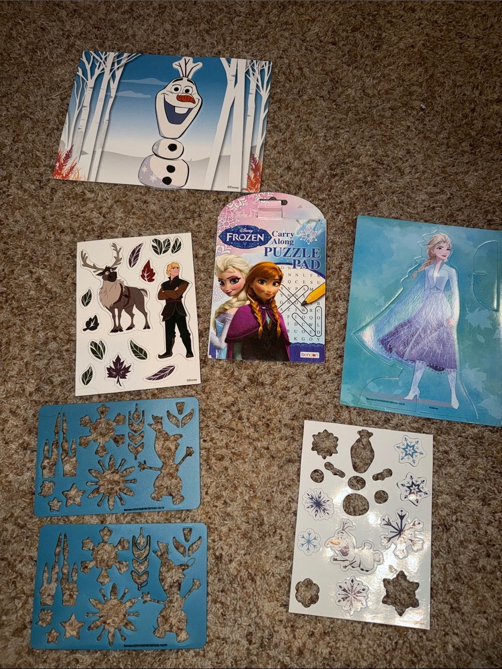 Disney Frozen themed activities, including a puzzle pad/magnets/stencils